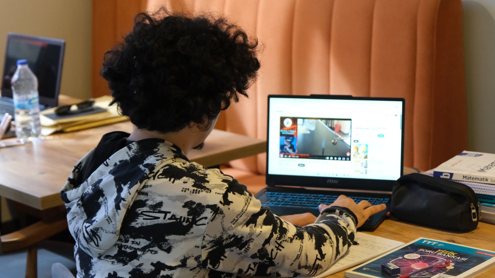 A pupil working on a laptop at home