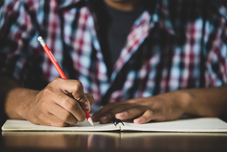 Student writing in a book