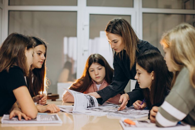 Students and teacher studying at school