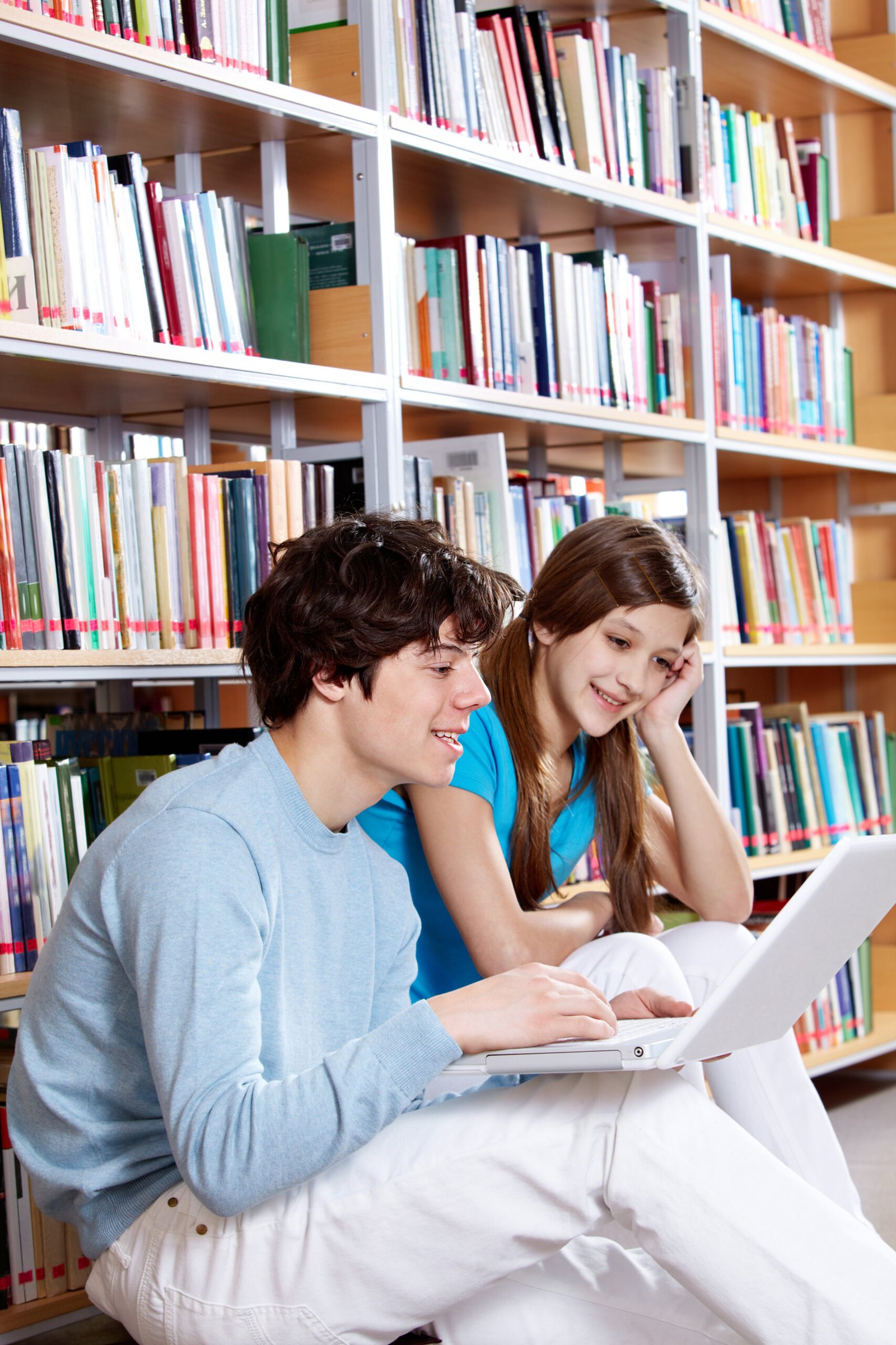 Guy and girl working in a library