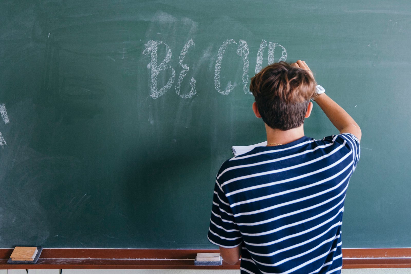 student writing words on a whiteboard