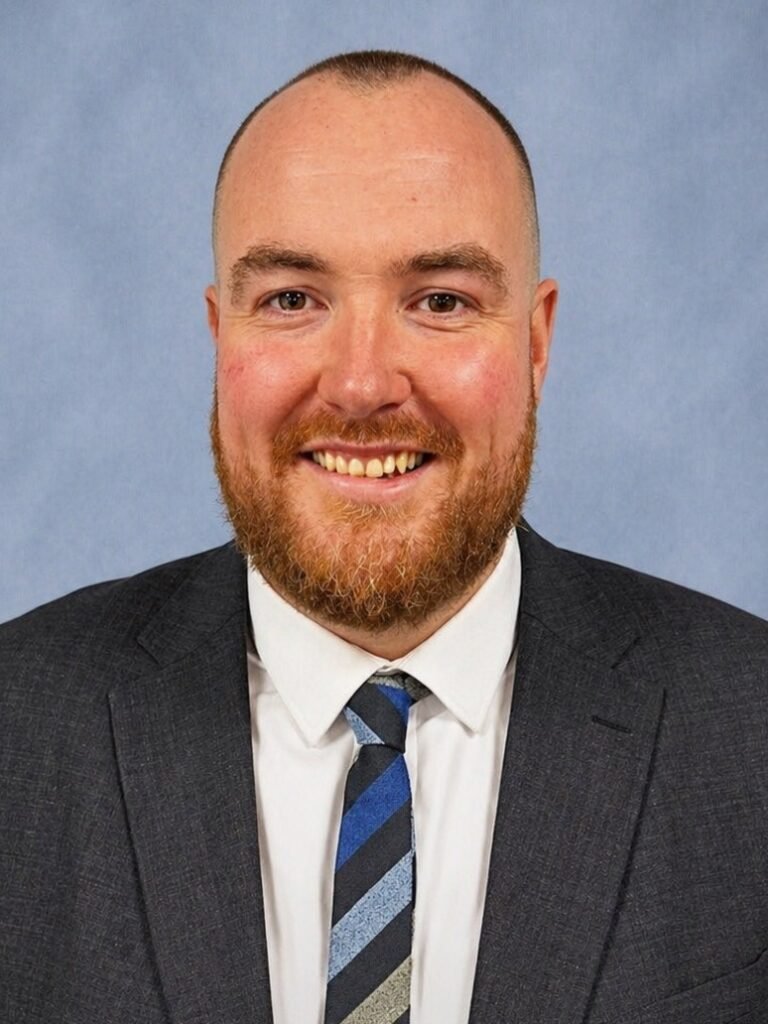 Professional headshot of Sam Gray